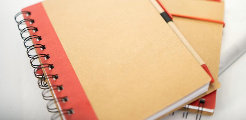 A wire-0 bound booklet laying on table.